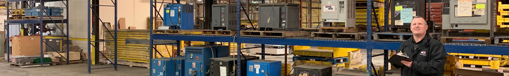 Warehouse shelving and a man with a clipboard